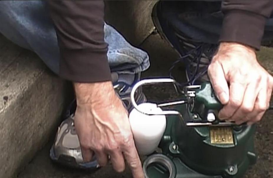 Hands Holding a Sump Pump