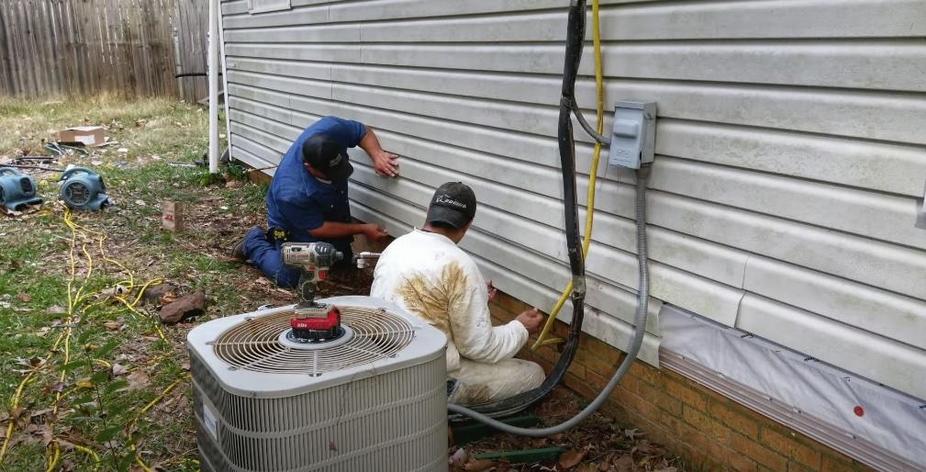 Two individuals repairing a foundation